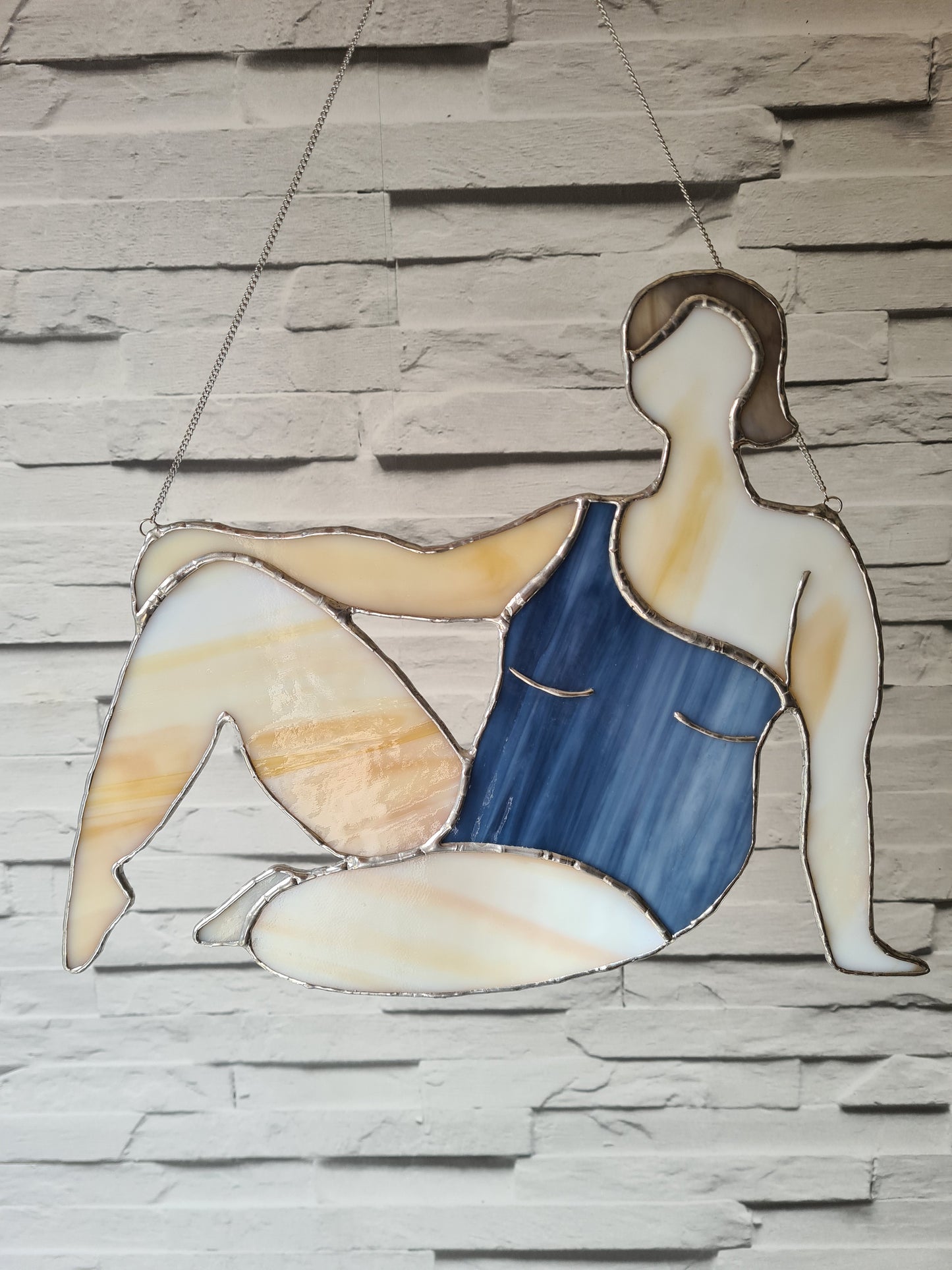 Stained glass suncatcher showing woman in swimsuit