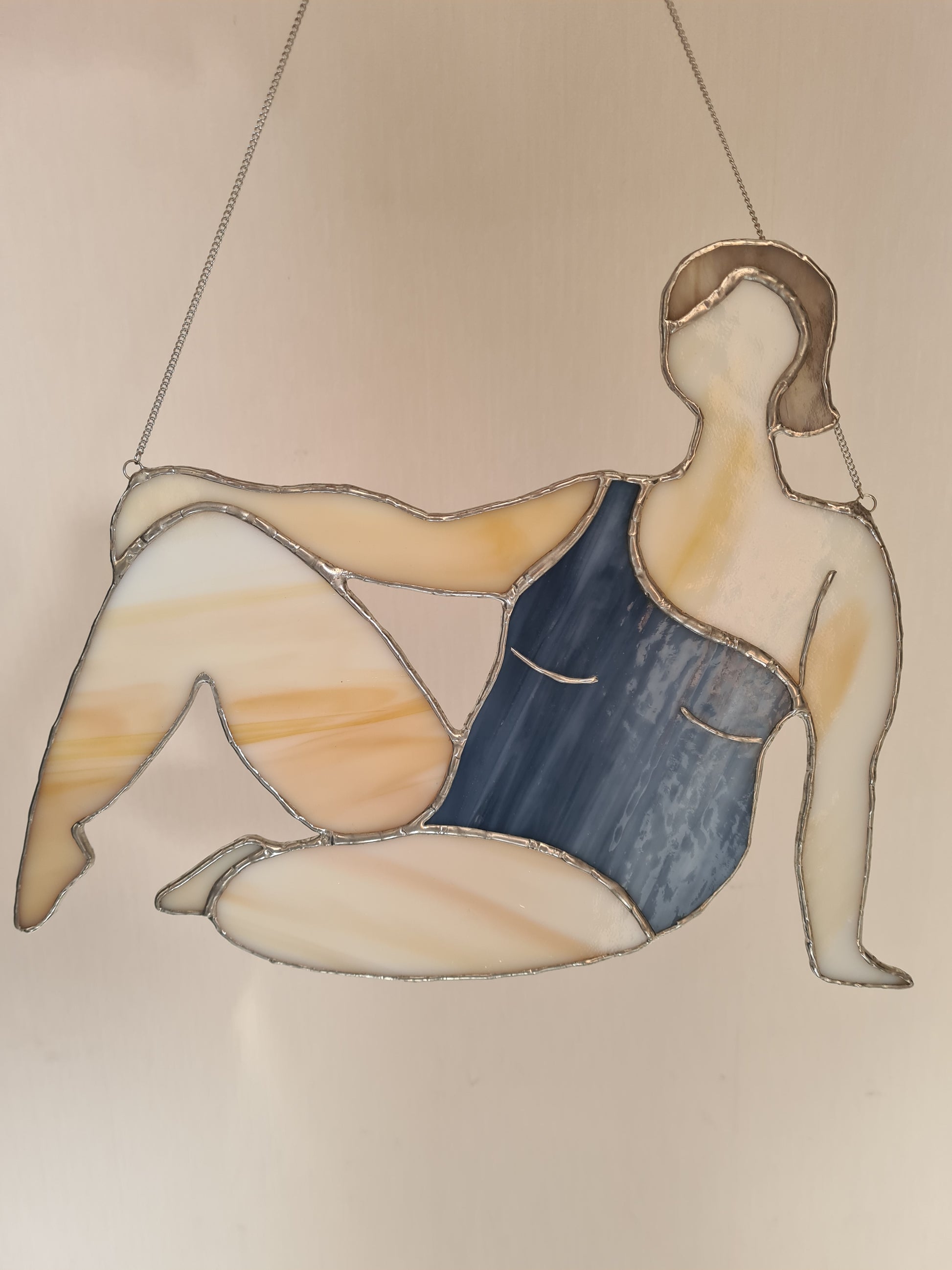 Stained glass suncatcher showing woman in swimsuit